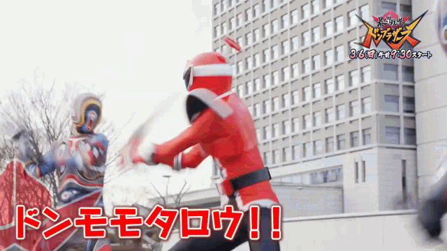 a man in a red superhero costume is fighting another man