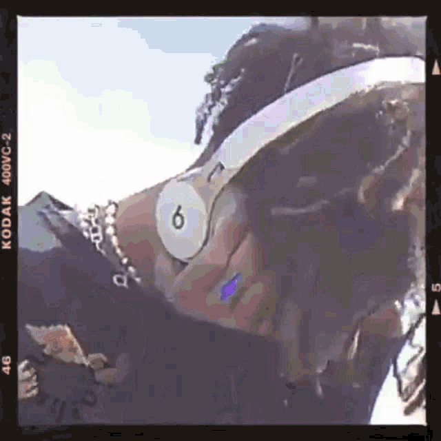 a person wearing headphones with the number 6 on them .