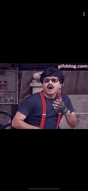 a man with a mustache and sunglasses is smoking a cigarette and says ada paavi .