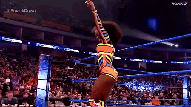 a woman in a wrestling ring is jumping in the air .