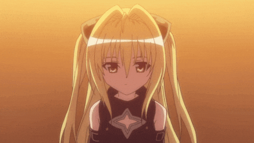 a girl with blonde hair and a black top has a star on her chest
