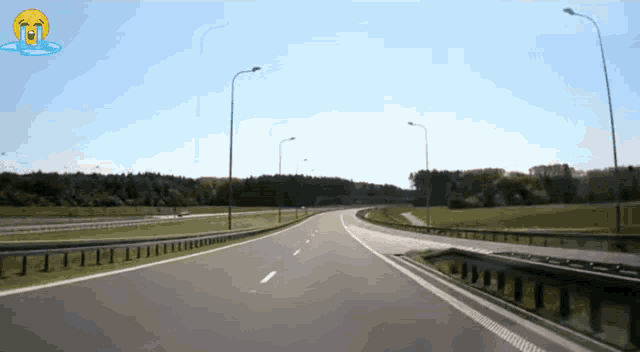 an empty highway with a crying face on the side of it