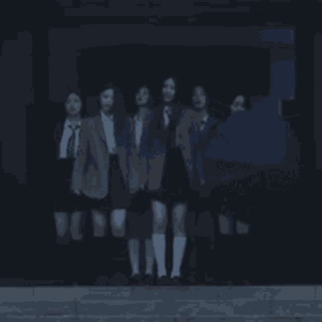 a group of people standing on a set of stairs with an umbrella