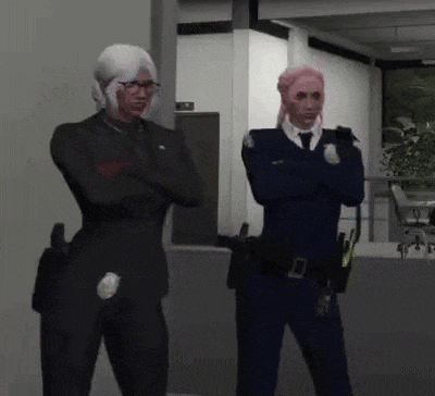 two police officers are standing next to each other in a room .