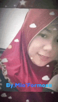 a woman wearing a red hijab with the name mia formosa on the bottom right