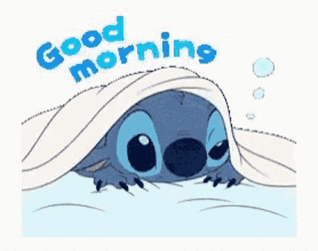 a cartoon of stitch laying under a blanket with the words `` good morning '' .