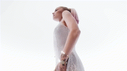 a woman with pink hair is covering her face with her hands