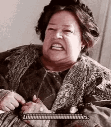 a close up of a woman making a funny face while holding a knife .