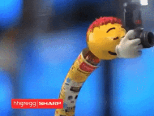 a sharp advertisement with a yellow smiley face holding a camera