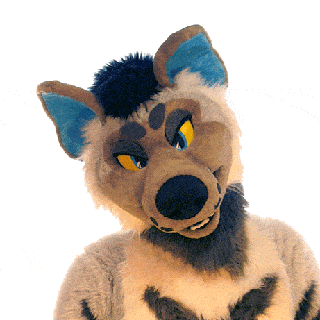 a stuffed animal with a blue ear and yellow eyes looks at the camera