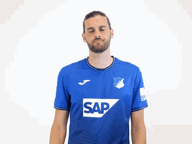 a man wearing a blue shirt with the word sap on the front