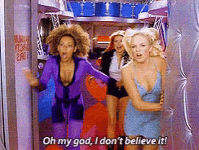 a woman in a blue dress is saying oh my god i don t believe it
