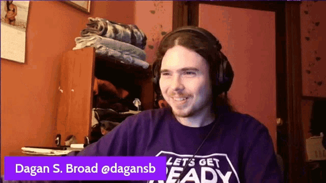 a man wearing headphones and a shirt that says " let 's get ready "