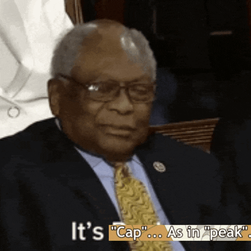a man in a suit and tie says it 's " cap "