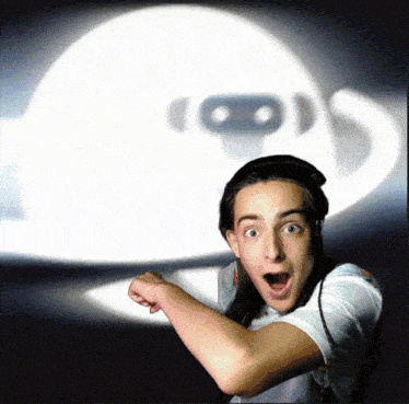 a man with a surprised look on his face in front of a white object