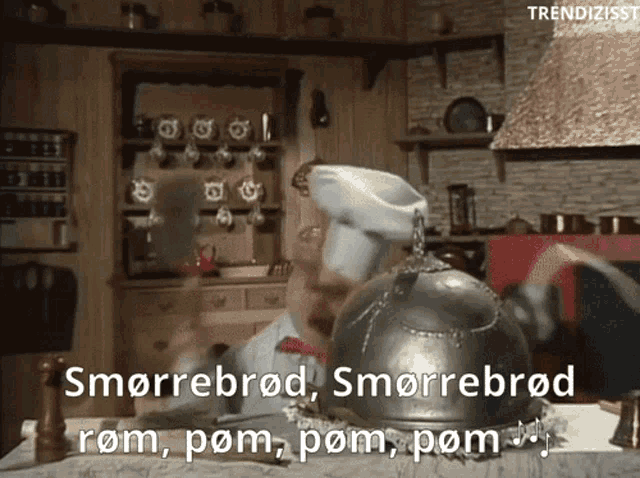 a chef in a kitchen with the words " smorrebrød " on the bottom right