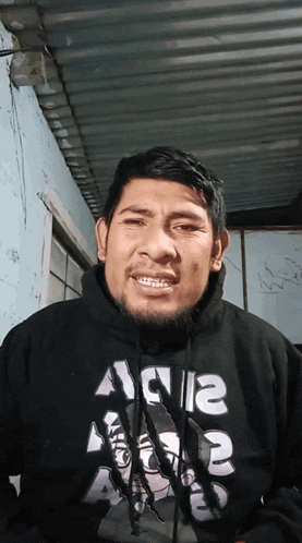 a man wearing a black hoodie that says a1a12 on it