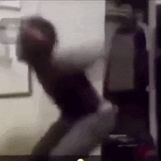 a blurry picture of a person sitting on a couch in a room .