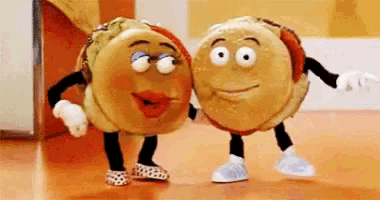 a couple of hamburgers with arms and legs are dancing together .