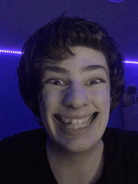 a young man making a funny face with his mouth open