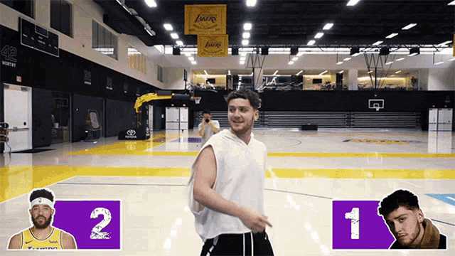 a man in a white tank top stands on a basketball court in front of a lakers banner
