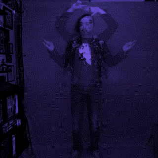 a blurry picture of a man in a t-shirt with a heart on it