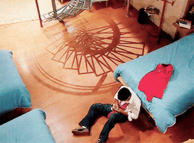 a person is laying on the floor in a bedroom with a spiral pattern on the floor