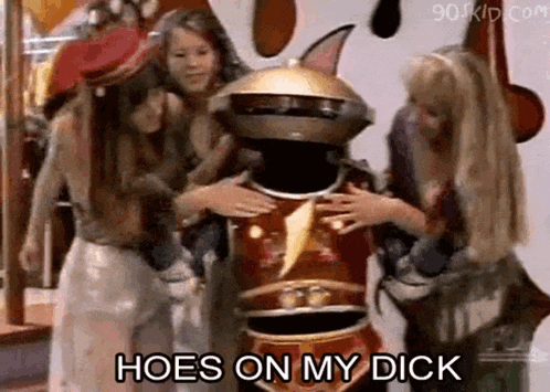 a group of girls are hugging a power ranger and they are saying hoes on my dick .