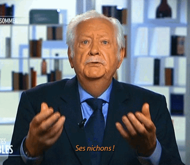 a man in a suit and tie says ses nichons in french