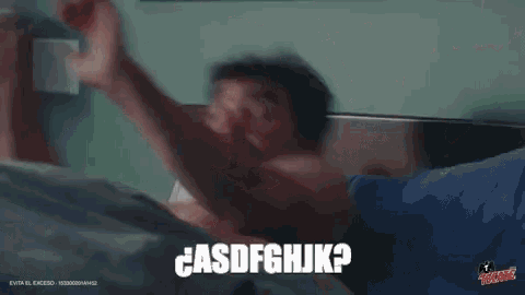 a shirtless man is sitting in a bathtub with the words " casdfghjk " above him .