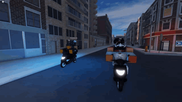two motorcycles are driving down a street in front of a brick building with a sign that says post office