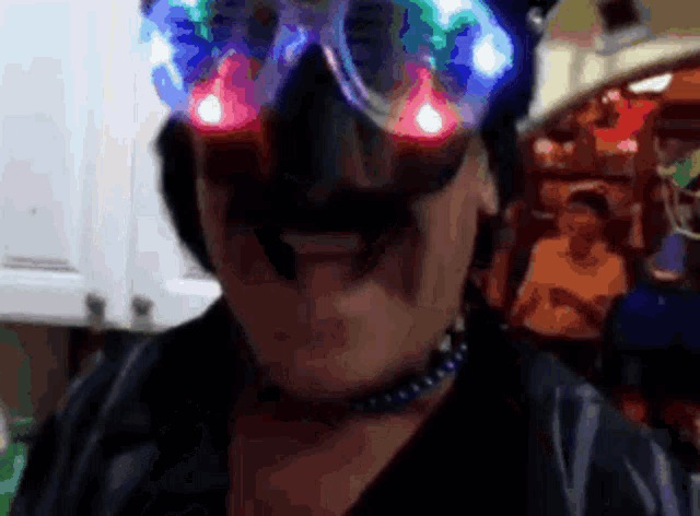a man with a mustache wearing a pair of glow in the dark glasses