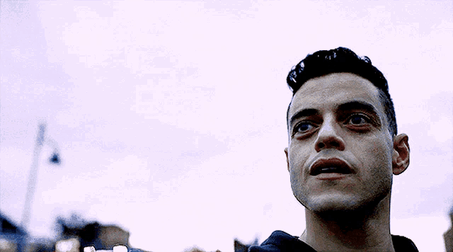a close up of a man 's face looking up at the sky