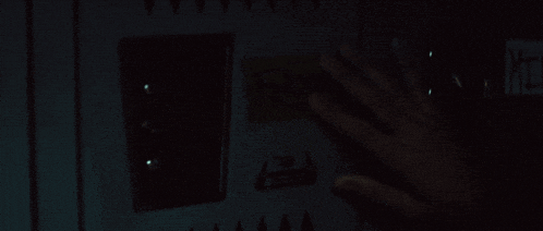 a blurry picture of a person 's back in a dark room