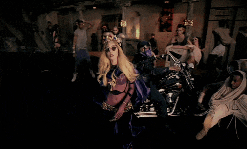a lady in a purple dress stands in front of a motorcycle that says harley davidson on it