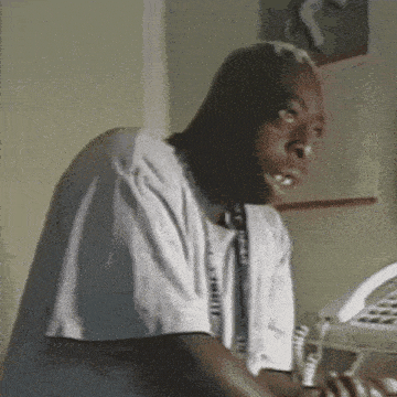 a man in a white shirt with a necklace that says t-shirt