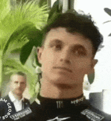 a close up of a man wearing a monster energy shirt and looking at the camera .
