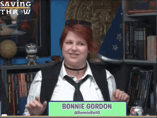 a woman in a white shirt and black tie is holding a sign that says bonnie gordon