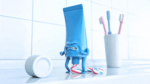 a tube of toothpaste with arms and legs is sitting on a counter
