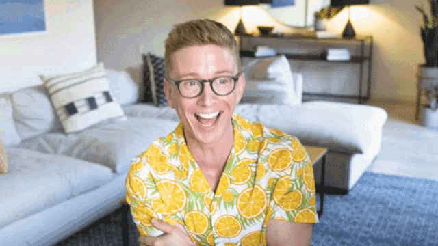 a man wearing glasses and a shirt with lemons on it