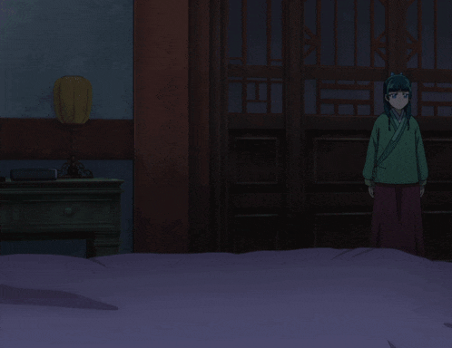 a girl in a green kimono stands on a bed