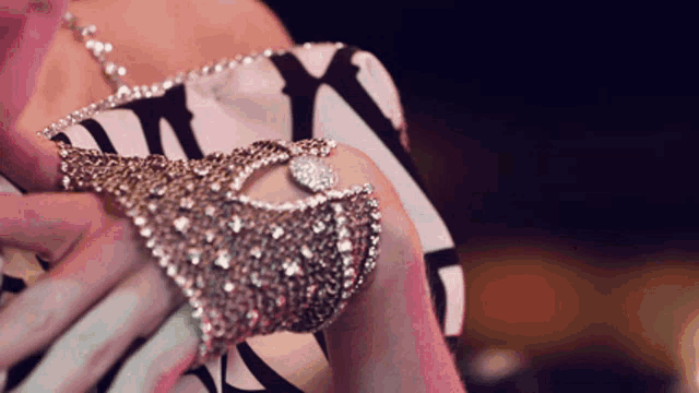 a close up of a woman wearing a bracelet with rhinestones