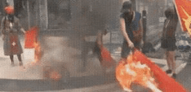 a canadian flag is burning in front of a store