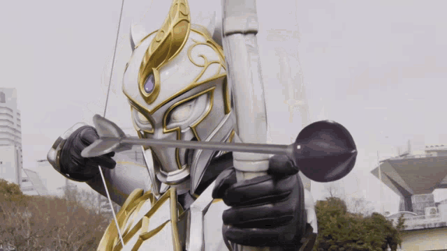 a cartoon character is holding a bow and arrow in front of a building