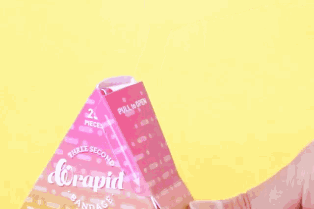 a person is opening a pink box that says ' three seconds ' on it .