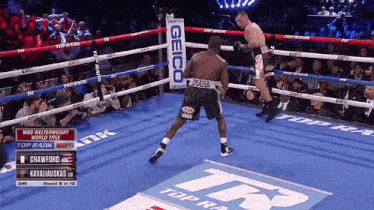 two boxers in a boxing ring with a geico sign behind them