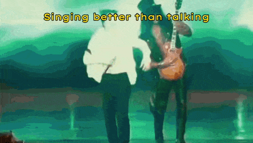 a man singing better than talking while another man plays guitar