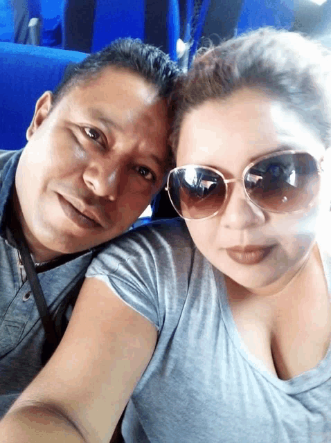 a man and a woman wearing sunglasses pose for a selfie