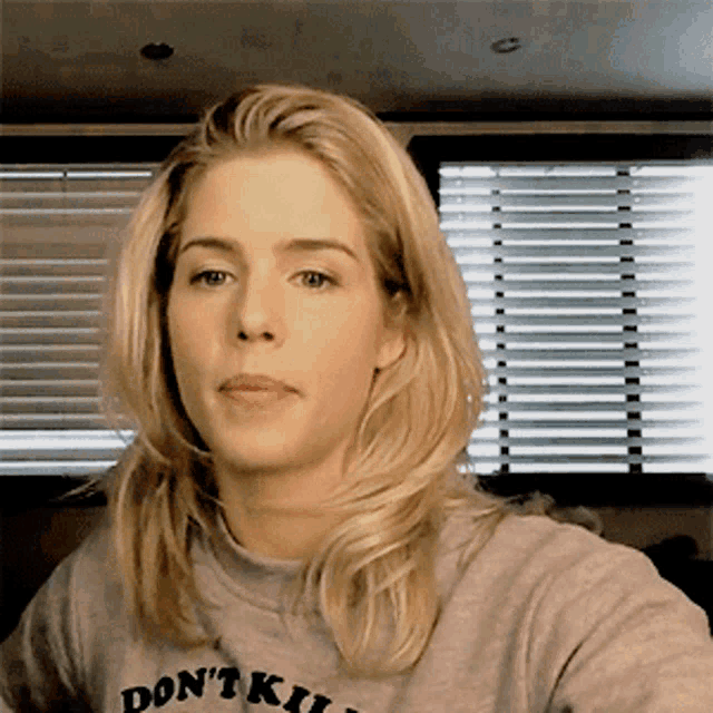 a woman wearing a t-shirt that says " don 't kill "