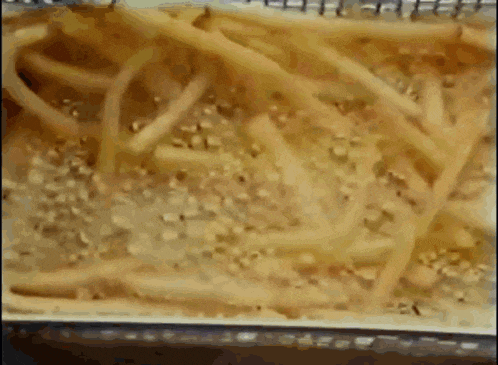 french fries are being cooked in a fryer